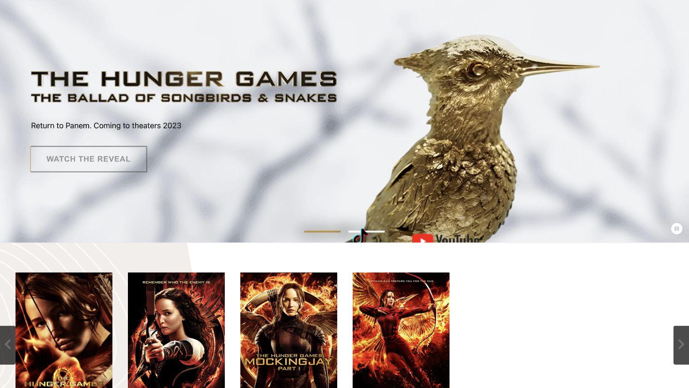 Historical Hunger Games campaign homepage with the golden songbird hero and responsive movie gallery